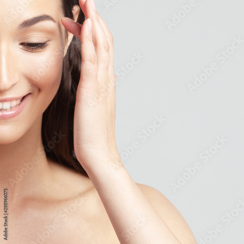 Young beautiful woman with clean perfect skin close-up.