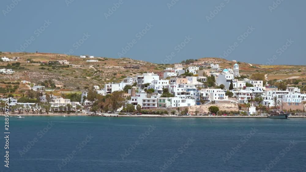 Panoramic view of Adamantas, harbor town of Milos island. Port at Aegean sea, iconic Cyclades Islands. Amazing greek architecture of luxury resort. White houses on hill and yachts on sunny quay Panoramic view of Adamantas, harbor town of Milos island. Port at Aegean sea, iconic Cyclades Islands. Amazing greek architecture of luxury resort. White houses on hill and yachts on sunny quay