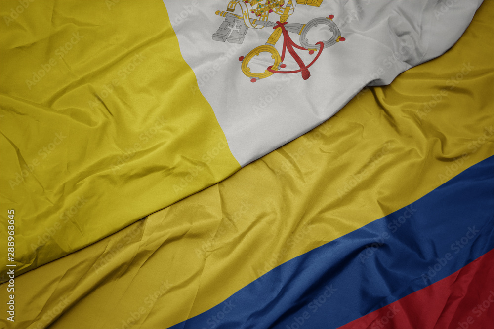 waving colorful flag of colombia and national flag of vatican city.