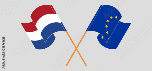 Crossed and waving flags of Netherlands and the EU