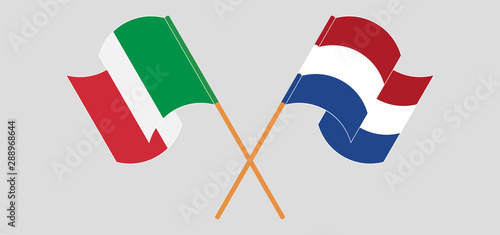 Crossed and waving flags of Netherlands and Italy