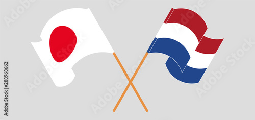 Crossed and waving flags of Netherlands and Japan
