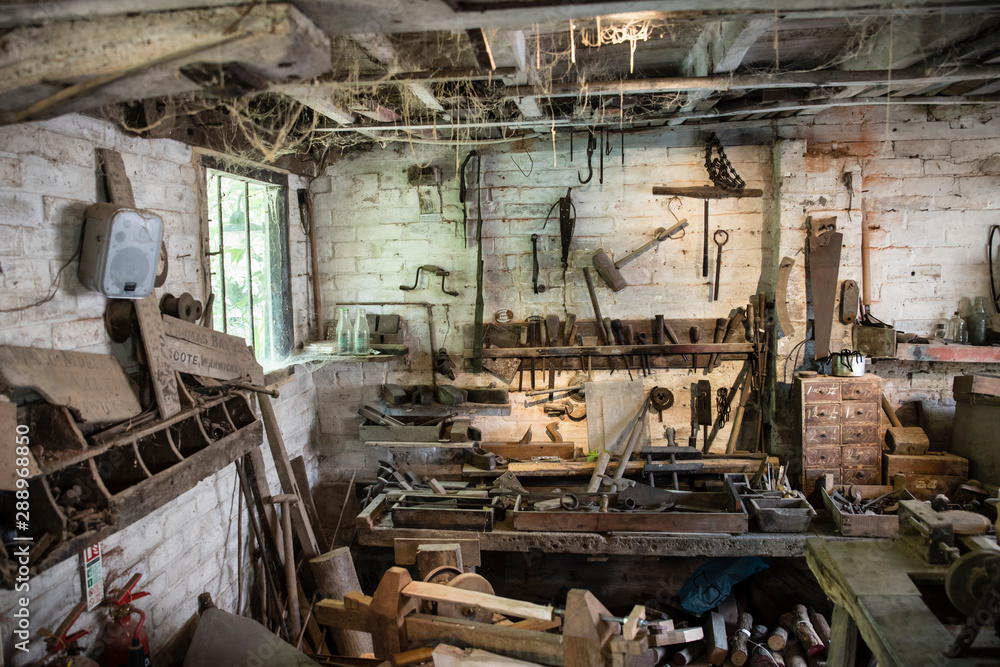 An abandoned workshop with dusty tools and cobwebs in front of a dirty window. An abandoned workshop with dusty tools and cobwebs in front of a dirty window.