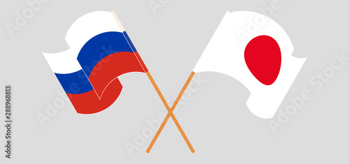 Crossed and waving flags of Japan and Russia