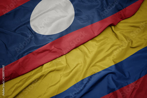 waving colorful flag of colombia and national flag of laos.