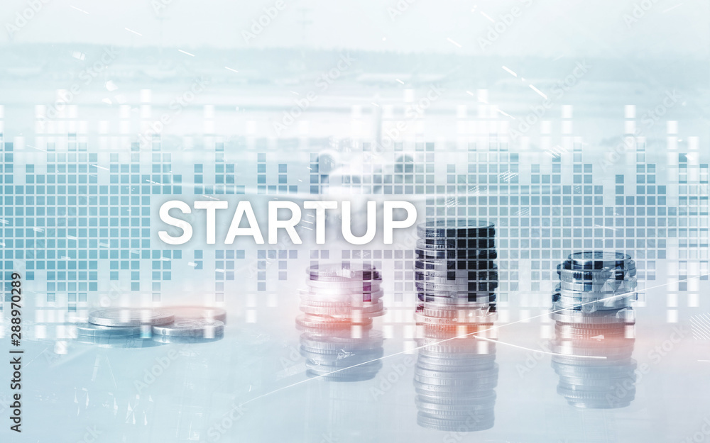 Successful teamwork and business startup concept. Inscription on the screen: Startup. Business World Economy Successful teamwork and business startup concept. Inscription on the screen: Startup. Business World Economy
