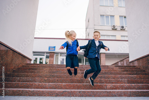 Young students, boy and girl, going to school