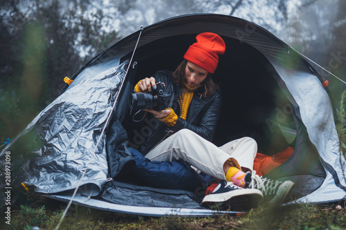 photographer tourist traveler take photo on camera in camp tent in foggy rain forest, hiker woman shooting mist nature trip, rest vacation concept camping holiday