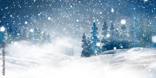 Natural Winter Christmas background with blue sky, heavy snowfall, snowflakes, snowy coniferous forest, snowdrifts. Winter landscape with falling christmas shining beautiful snow.