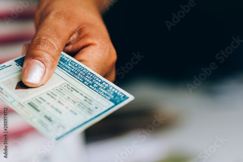 Man holds National Driver's License (CNH). Official document of Brazil, which attests the ability of a citizen to drive land vehicles.