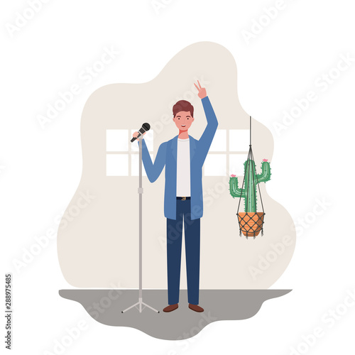 young man with microphone and houseplants on macrame hangers of background