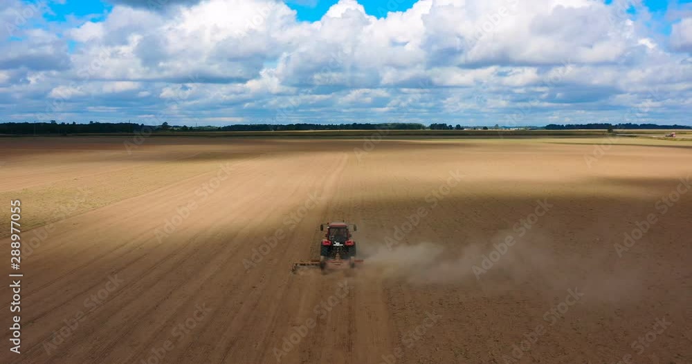 Aerial view drone of harvest field with tractor mows dry grass. Autumn yellow field with a haystack after harvest top view. Harves. Ting in the fields. Stock up