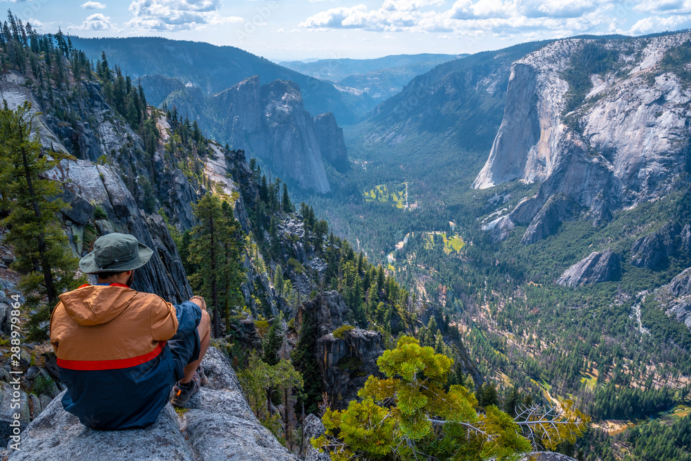 A young winged seated Taft point looking at Yosemite National Park and El Capitan. United States