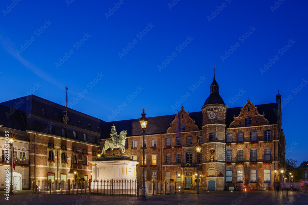 Night scenery of historical old town city centre, market square, statue monument and background of Old Town Hall in Düsseldorf, Germany.