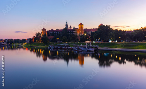 Wawel castle at sunrise reflected in the Vistula river © alexmu