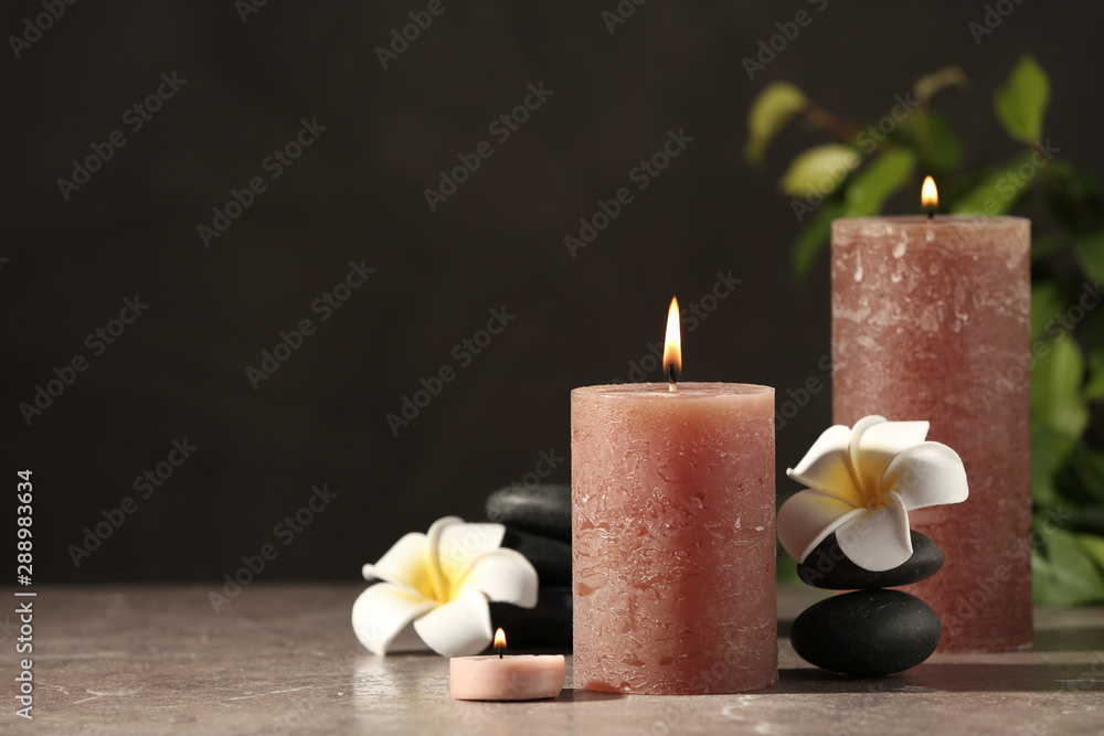 Composition with candles and spa stones on marble table. Space for text Composition with candles and spa stones on marble table. Space for text