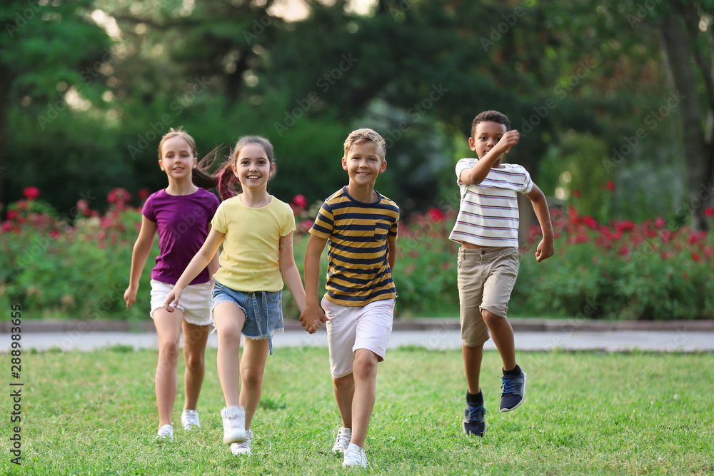 Cute smiling little children playing in park Cute smiling little children playing in park