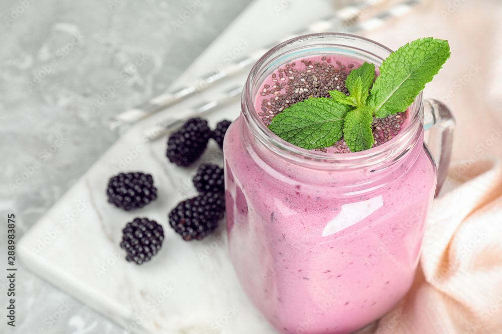 Delicious blackberry smoothie in mason jar on marble table Delicious blackberry smoothie in mason jar on marble table