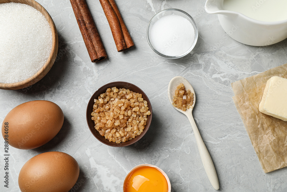 Flat lay composition with fresh ingredients for delicious homemade cake on light grey marble table Flat lay composition with fresh ingredients for delicious homemade cake on light grey marble table
