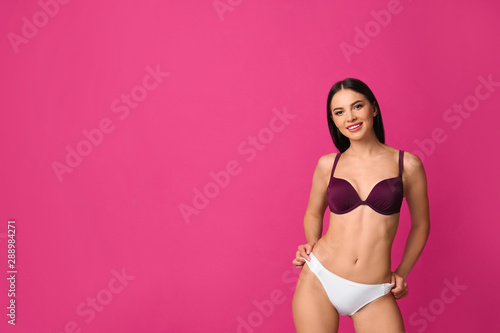 Beautiful young woman in stylish bikini on pink background. Space for text