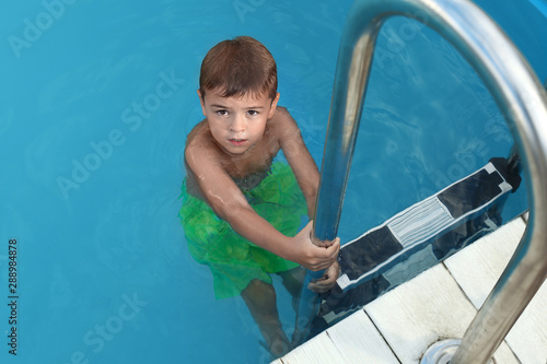 Photos Little child getting out of outdoor swimming pool