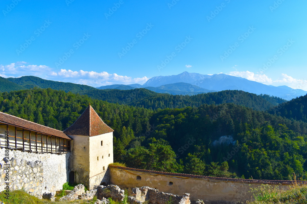 Panoramic landscape featuring historic Romanian fortress and its stone walls in the mountains of Transylvania. Boiana Brasov, Romania, the Balkans, Eastern Europe