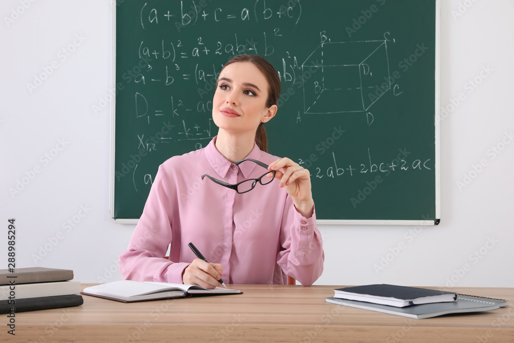Portrait of young female teacher in classroom Portrait of young female teacher in classroom
