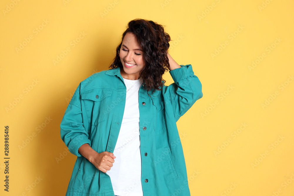 Happy young woman in casual outfit on yellow background Happy young woman in casual outfit on yellow background