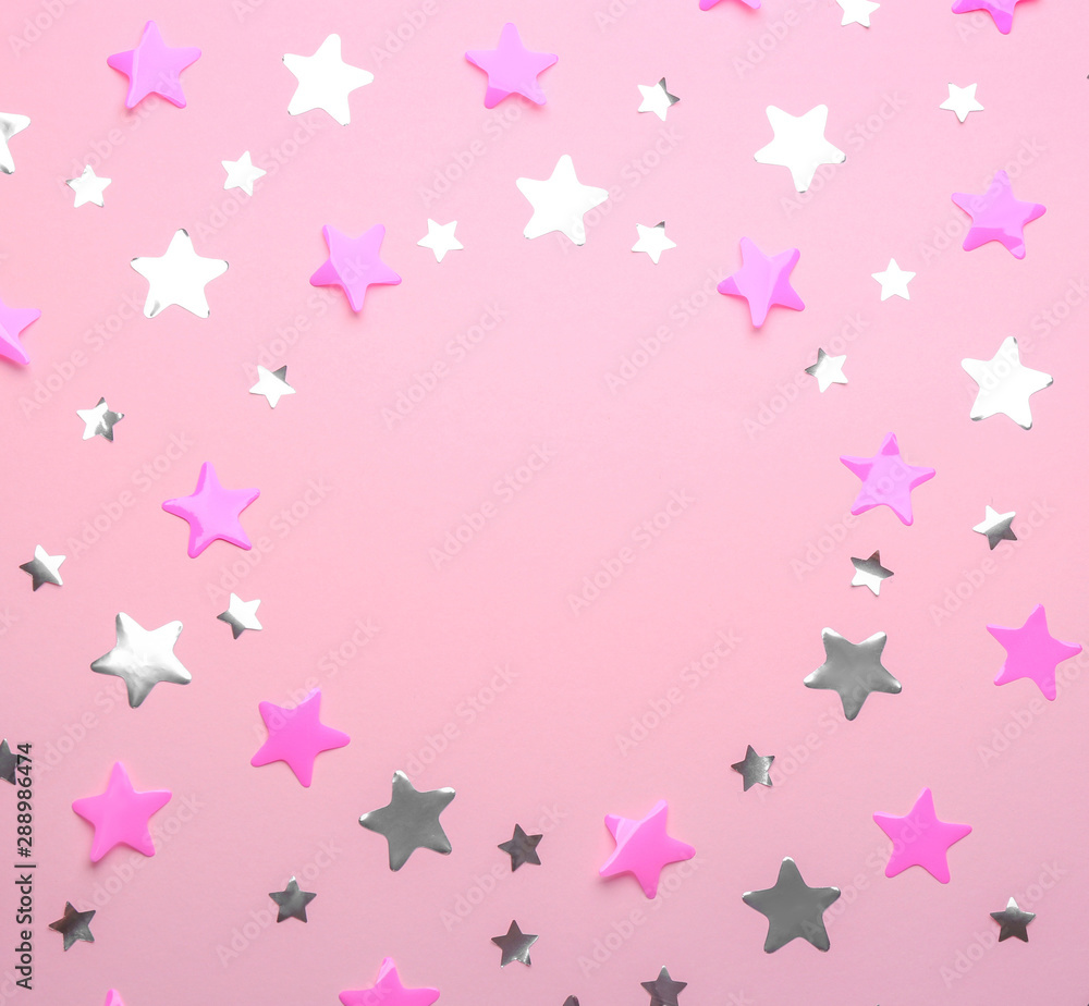 Frame made of confetti stars with space for text on pink background, top view. Christmas celebration