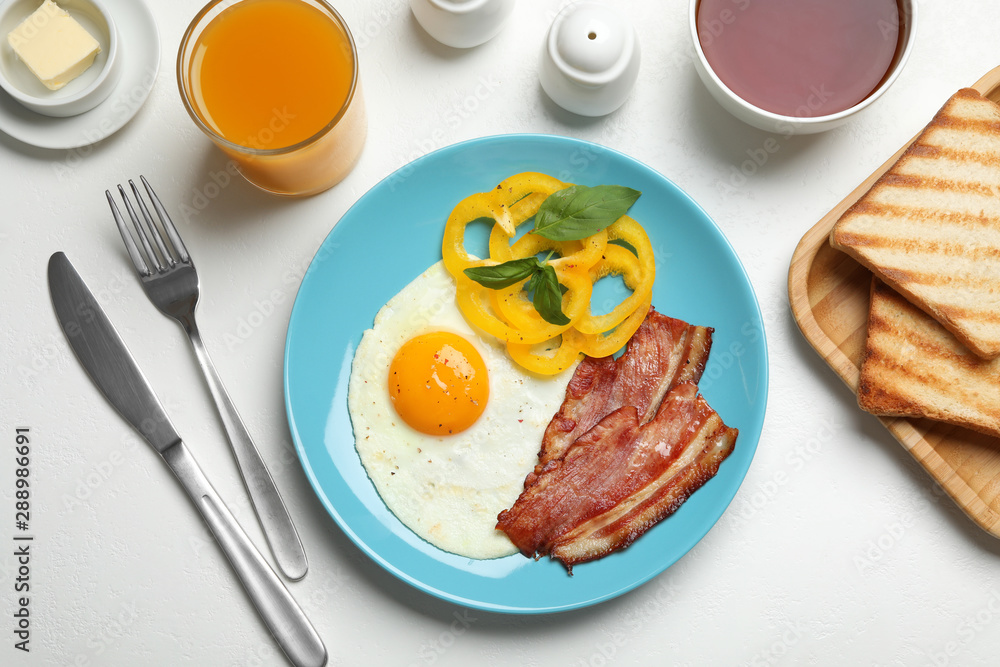 Tasty breakfast with fried egg served on light table, flat lay Tasty breakfast with fried egg served on light table, flat lay