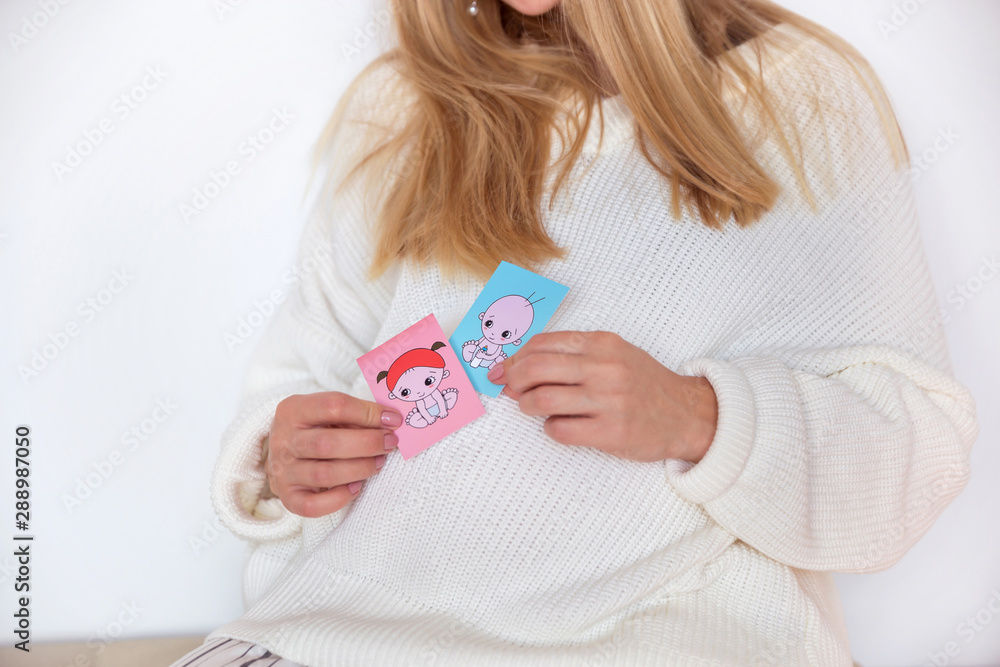 Girl in a white sweater and warm socks, sitting on a soft pillow in a Scandinavian style Girl in a white sweater and warm socks, sitting on a soft pillow in a Scandinavian style