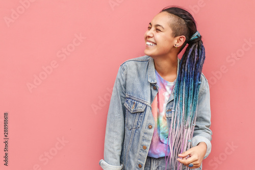 Young stylish girl on color wall background