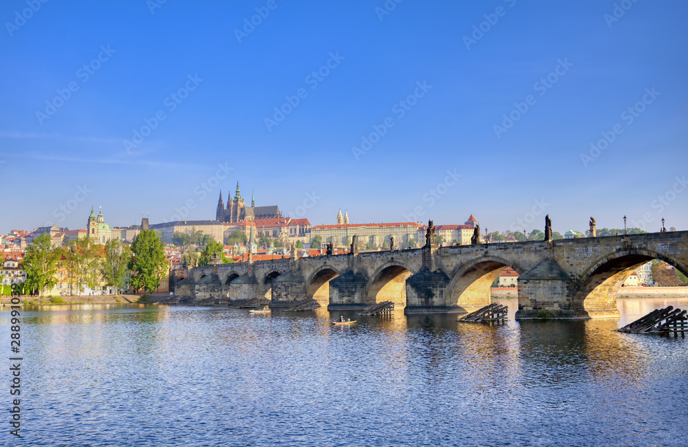Fototapeta premium A view across the Charles Bridge and the Vltava River to Prague Castle and St. Vitas Cathedral in Prague, Czech Republic.