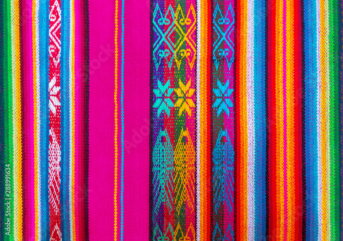 Colorful Andes textiles on the art and craft market of Otavalo, north of Quito, in Ecuador. These traditional fabrics can also be found in Peru and Bolivia. photo