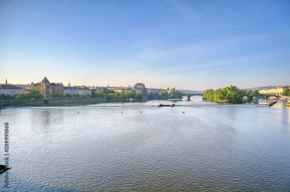 Fototapeta premium Early morning view of the along the Vltava River in the city of Prague, Czech Republic.
