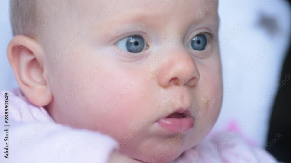 Close up portrait of 5 month old Beautiful Baby Girl with baby Food on her Face, Healthy Eating Close up portrait of 5 month old Beautiful Baby Girl with baby Food on her Face, Healthy Eating