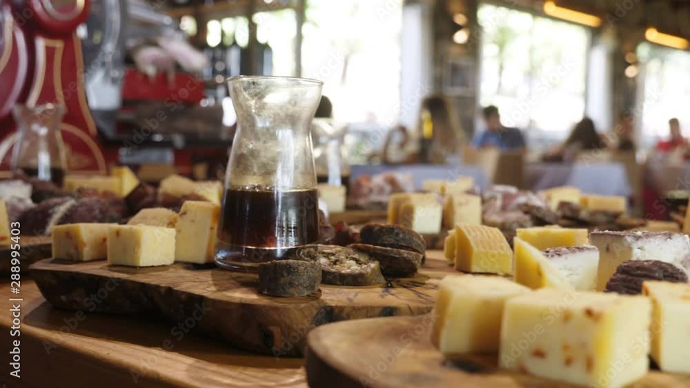 Cheese,salami and wine on wooden table.Mediterranean food and traditions Cheese,salami and wine on wooden table.Mediterranean food and traditions