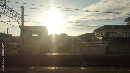 Japan Railway train window. Sunset and train departure