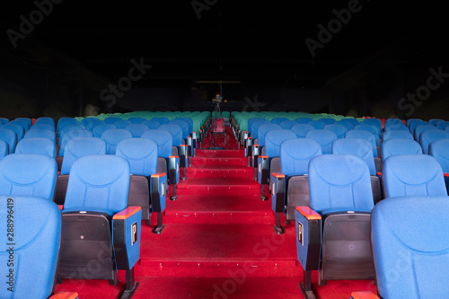 Red Blue Velvet Fabric Cloth Empty Many Seats Row Column in Movie film Theatre Concert or Siminar Conference premiere room with flare light photo