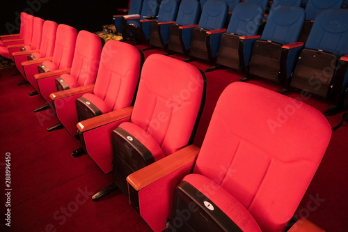 Red Blue Velvet Fabric Cloth Empty Many Seats Row Column in Movie film Theatre Concert or Siminar Conference premiere room with flare light photo