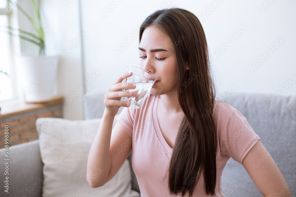 Young woman drinking water drinking a fresh glass of water at home. Young woman drinking water drinking a fresh glass of water at home.