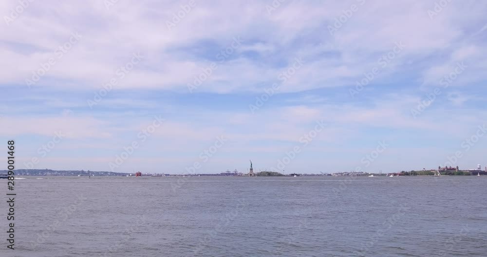 Distant view of the Statue of Liberty from the Battery Park in Lower Manhattan, New York. Distant view of the Statue of Liberty from the Battery Park in Lower Manhattan, New York.