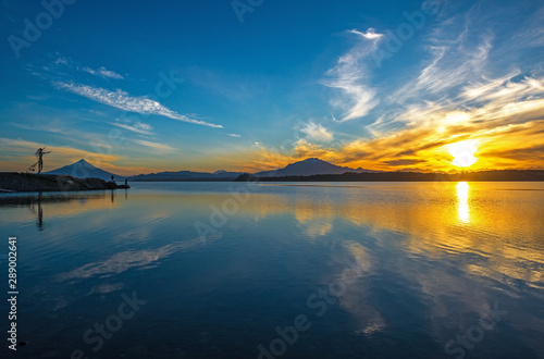 A landscape view of the Osorno and Calbuco volcano at sunrise by the Llanquihue Lake, Puerto Varas, Chile. photo