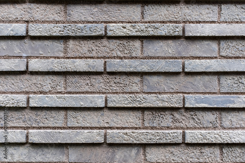 Closed up grey brick wall texture. Architectural material construction.