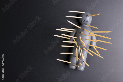 .Voodoo Doll on a black background with dramatic lighting.