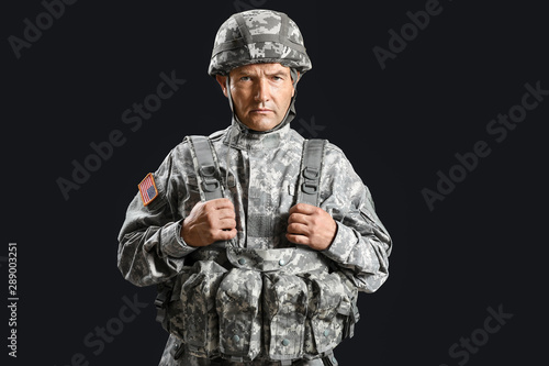 Mature male soldier on dark...
