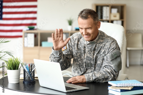 Mature male soldier using l...