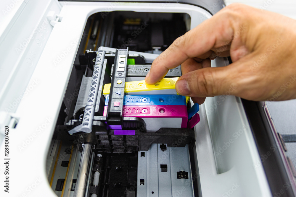 Technicians are install setup the ink cartridge or inkjet cartridge is a component of an inkjet printer