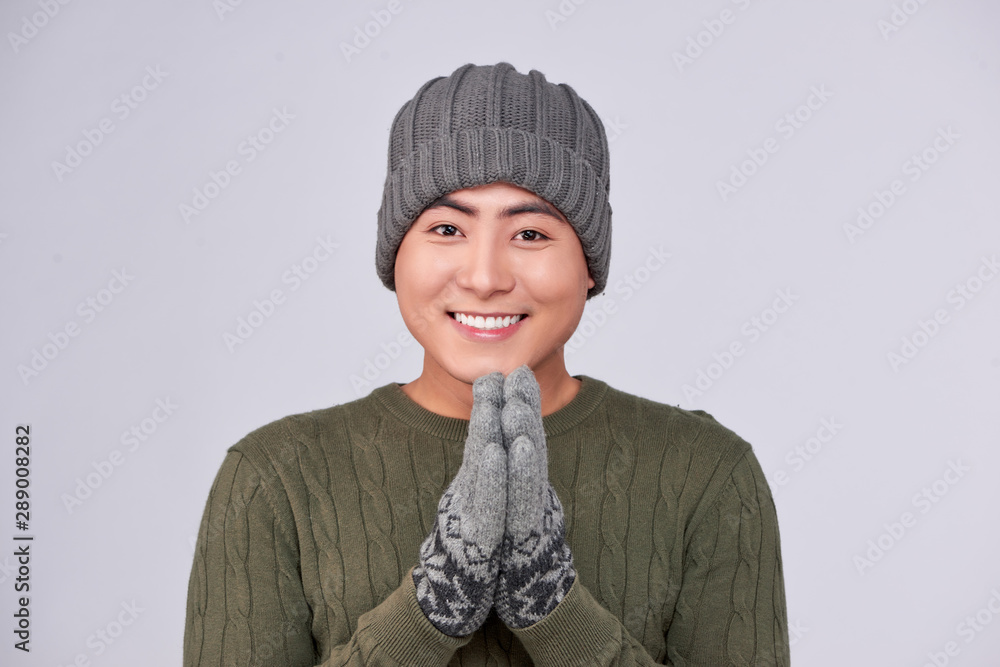 Handsome winter asian man in knitted woolen clothing hat