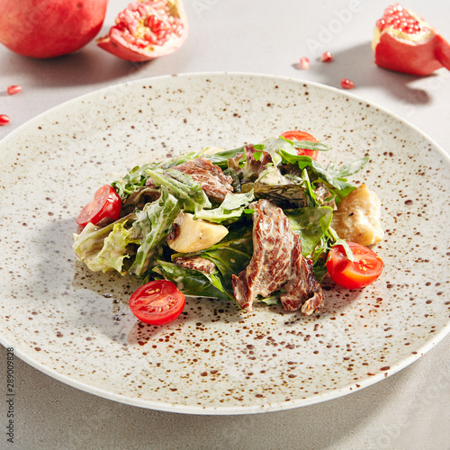 Warm salad with veal and porcini mushrooms in cream sauce photo